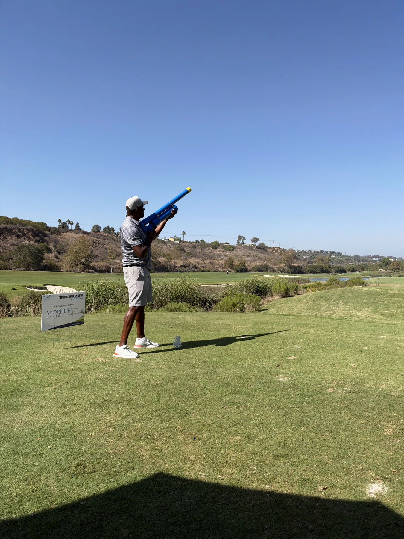 Golfer launching a golf cannon down the fairway at a tournament