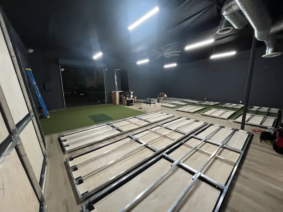 PureShot Indoor Golf in San Diego during setup, with simulator components laid out before assembly