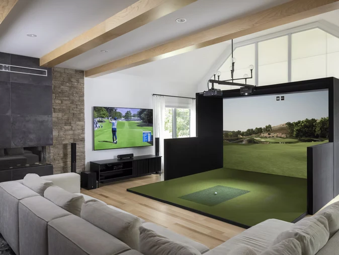 SimBooth golf enclosure integrated into a bright living room