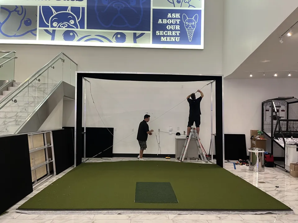 Team assembling the golf simulator enclosure at the Forum Shops in Las Vegas